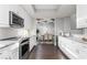 Open concept kitchen with white cabinets and dark hardwood floors at 437 W 86Th St, Indianapolis, IN 46260