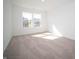 Well-lit bedroom with neutral walls and carpeting, plus a large window at 1550 Hanover St, Danville, IN 46122