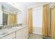 Charming bathroom with granite countertop, white cabinets, and striped curtains at 8358 Hidden Point Dr, Indianapolis, IN 46256