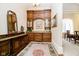 Butlers pantry with wooden cabinetry, granite countertops and a large mirror at 8358 Hidden Point Dr, Indianapolis, IN 46256