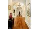 Elegant hallway with arched entryways, hardwood floors, and artwork at 8358 Hidden Point Dr, Indianapolis, IN 46256