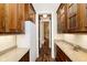 Walk-in pantry with wooden cabinetry, granite countertops and a refrigerator at 8358 Hidden Point Dr, Indianapolis, IN 46256