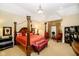 Luxurious main bedroom with a large four-poster bed and sitting area at 8358 Hidden Point Dr, Indianapolis, IN 46256