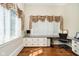Home office featuring built-in cabinetry, hardwood floors and window with curtains at 8358 Hidden Point Dr, Indianapolis, IN 46256