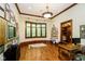 Home office with hardwood floors, built-in shelving, and large windows at 8358 Hidden Point Dr, Indianapolis, IN 46256
