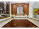 Wet bar with wooden cabinetry, granite countertop and glass-front cabinets at 8358 Hidden Point Dr, Indianapolis, IN 46256