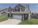 Two-story house with gray siding, brick accents, and a two-car garage at 2277 Maple Stone Ln, Greenwood, IN 46143