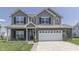 Two-story house with gray siding, brick accents, and a two-car garage at 2277 Maple Stone Ln, Greenwood, IN 46143