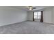 Large bedroom with grey carpet, ceiling fan and window at 2277 Maple Stone Ln, Greenwood, IN 46143