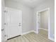 Simple hallway with light gray walls and light wood flooring at 11419 Neptune Dr, Fishers, IN 46040