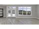 Living area with hardwood floors and access to backyard patio at 11419 Neptune Dr, Fishers, IN 46040