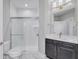 Modern bathroom with subway tile shower and dark vanity at 11419 Neptune Dr, Fishers, IN 46040