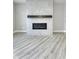 Modern gas fireplace with gray tile surround and wood mantel at 11419 Neptune Dr, Fishers, IN 46040