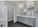 Double vanity bathroom with gray cabinets and marble shower at 11419 Neptune Dr, Fishers, IN 46040