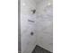 Modern shower with marble tile and gold fixtures at 11419 Neptune Dr, Fishers, IN 46040