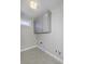 Laundry room with gray cabinets and tile floor at 11419 Neptune Dr, Fishers, IN 46040
