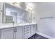 Double vanity bathroom with gray cabinets and marble-look tile at 11419 Neptune Dr, Fishers, IN 46040