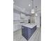 Modern kitchen with white cabinets, quartz countertops, and a navy island at 11419 Neptune Dr, Fishers, IN 46040