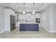 Modern kitchen with white cabinets, quartz counters, and a navy island at 11419 Neptune Dr, Fishers, IN 46040