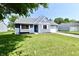 Exterior of a charming blue house with a neatly landscaped lawn and attached garage at 2813 Grassy Creek Dr, Indianapolis, IN 46229