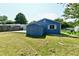 Backyard view showing a blue house with a patio, shed and grassy area at 2813 Grassy Creek Dr, Indianapolis, IN 46229