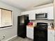 Efficient kitchen with white cabinets and black appliances at 2813 Grassy Creek Dr, Indianapolis, IN 46229