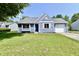 Exterior of a charming blue house with a neatly landscaped lawn and attached garage at 2813 Grassy Creek Dr, Indianapolis, IN 46229