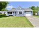 Exterior of a charming blue house with a neatly landscaped lawn and attached garage at 2813 Grassy Creek Dr, Indianapolis, IN 46229