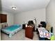 Bright bedroom with a double bed, a desk, and carpeted flooring at 2813 Grassy Creek Dr, Indianapolis, IN 46229