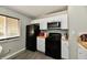Modern kitchen with white cabinets, black appliances, and wood countertops at 2813 Grassy Creek Dr, Indianapolis, IN 46229