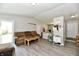 Open living room with kitchen view, two sofas, and access to backyard at 2813 Grassy Creek Dr, Indianapolis, IN 46229