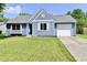 Exterior of a charming blue house with a neatly landscaped lawn and attached garage at 2813 Grassy Creek Dr, Indianapolis, IN 46229