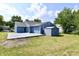 Backyard view showing a blue house with a patio, shed and grassy area at 2813 Grassy Creek Dr, Indianapolis, IN 46229
