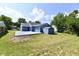 Backyard view showing a blue house with a patio, shed and grassy area at 2813 Grassy Creek Dr, Indianapolis, IN 46229
