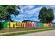 Colorful fence mural depicting children playing at 32 E Caven St, Indianapolis, IN 46225