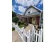 Charming 2-story home with gray siding and white picket fence at 32 E Caven St, Indianapolis, IN 46225