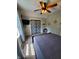 Bright bedroom with a ceiling fan, carpet, and large bed at 32 E Caven St, Indianapolis, IN 46225