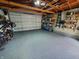Garage with flake flooring, shelves, and bikes at 32 E Caven St, Indianapolis, IN 46225