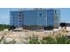 Exterior view of a modern glass office building under construction at 32 E Caven St, Indianapolis, IN 46225