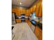 Well-equipped kitchen with wood cabinets, stainless steel appliances, and granite counters at 32 E Caven St, Indianapolis, IN 46225