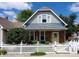 Charming 2-story home with gray siding and white picket fence at 32 E Caven St, Indianapolis, IN 46225
