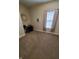 Bright home office features a window with blinds, carpeted floor, and a desk with chair at 32 E Caven St, Indianapolis, IN 46225