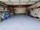 Garage with flake flooring, shelves, and bikes at 32 E Caven St, Indianapolis, IN 46225