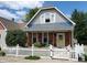Charming 2-story home with gray siding and white picket fence at 32 E Caven St, Indianapolis, IN 46225