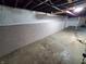Unfinished basement with painted concrete walls at 32 E Caven St, Indianapolis, IN 46225