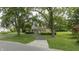 Ranch style home with green lawn and mature trees at 449 Emerson Rd, Carmel, IN 46032