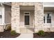 Modern front door entrance with stone columns at 15798 Vitalize Run, Fishers, IN 46040