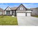 Two-story home with stone accents and a three-car garage at 15827 Scarteen Rd, Fishers, IN 46040