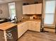 Galley kitchen with white cabinets and butcher block counters at 1202 S Shipley St, Muncie, IN 47302