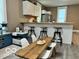 Modern kitchen with white cabinets, butcher block island, and eat-in dining area at 1202 S Shipley St, Muncie, IN 47302